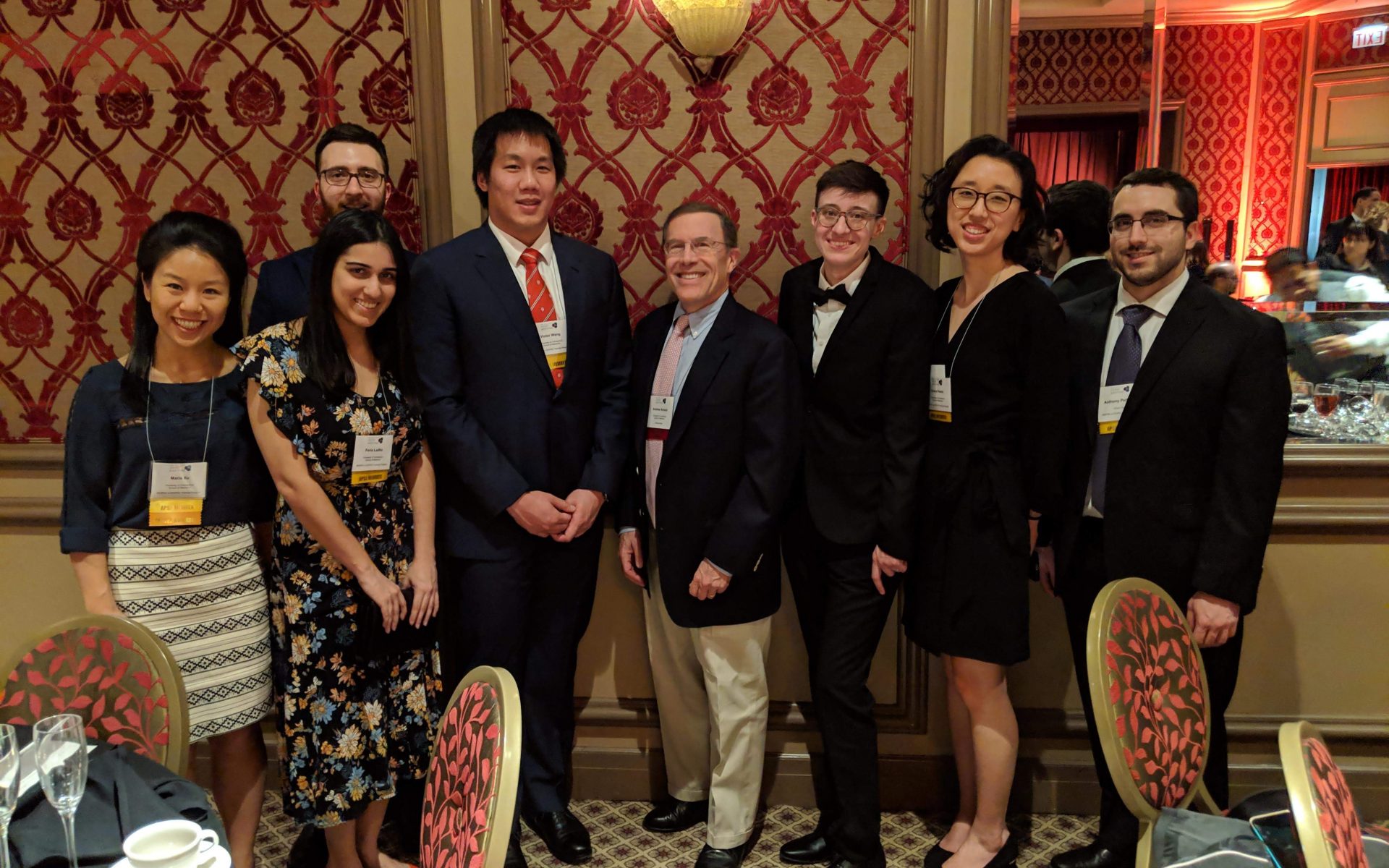 UConn MD/PhD students standing together smiling, nicely dressed in a fancy ballroom