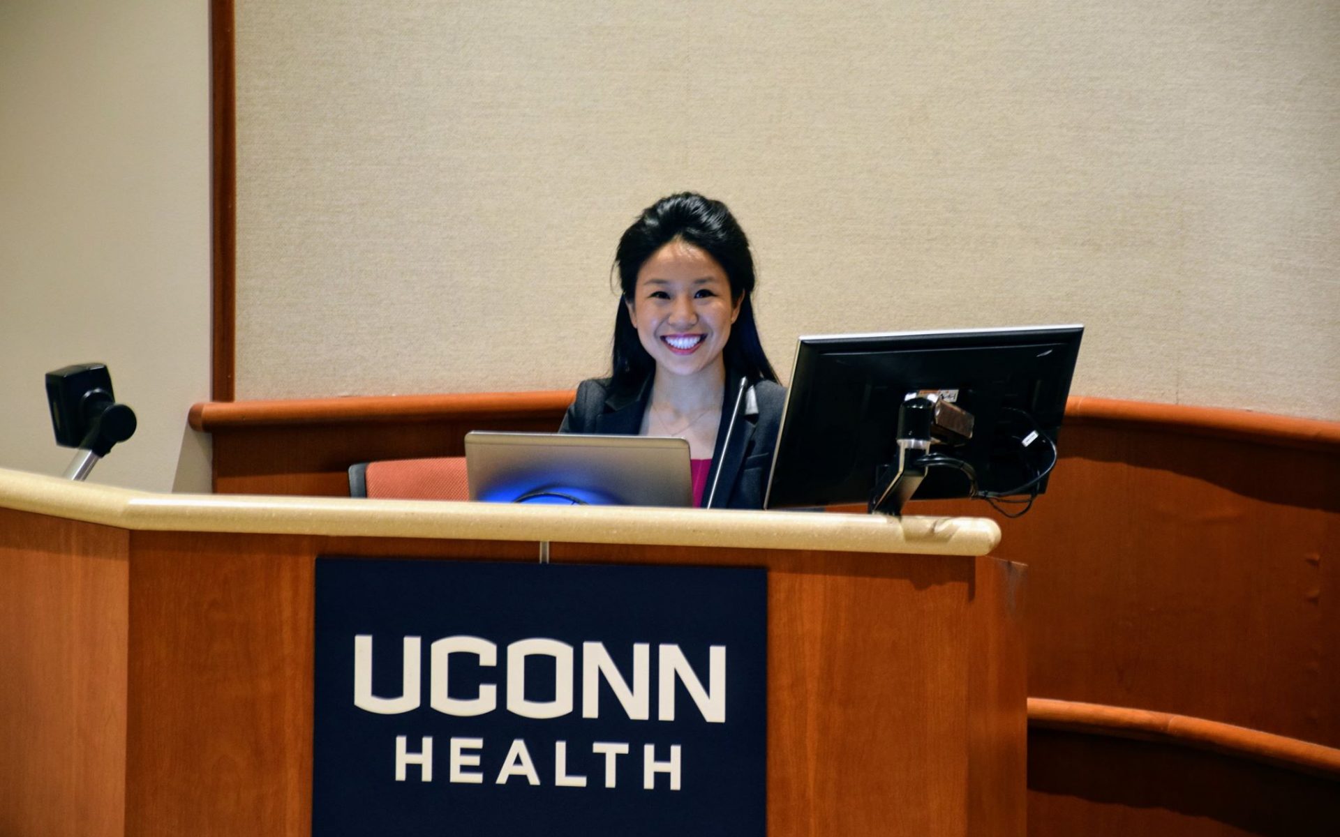 Maria Smiling at the Low Learning Center Podium